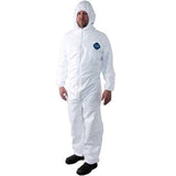 A person wearing a Dupont Tyvek 400 TY127S Coverall Suit with a hood stands against a plain background. This disposable work suit, featuring the distinctive blue chest label, is ideal for tasks such as toxic material abatement. The outfit is completed with black shoes, adding to the protective ensemble.