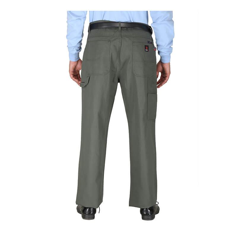 A person in a light blue shirt and dark belt is shown from the back wearing the ForgeFR Carpenter Pants Green Duck, which feature convenient pockets and a relaxed fit for comfort and ease of movement. They are standing on a white background, complementing their look with black shoes.