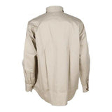 The ForgeFR Forge FR Solid Button Shirt MFRLB2PS024, crafted from FRARCTEX FR fabric in beige, is displayed from the back. It includes a collar and buttoned cuffs, has a loose fit with a minimalistic design, and offers an additional layer of safety with an ATPV arc rating of 8.8 cal/cm2.