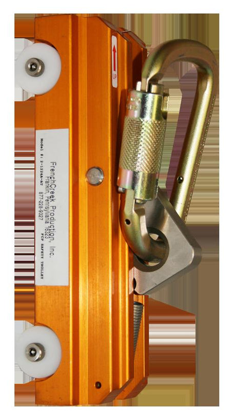 A close-up view reveals an orange climbing safety device, resembling the French Creek Trolley for Rigid Rail Vertical Climbing Systems by French Creek Production. This device includes an attached carabiner, features wheels, displays an "UP" arrow, and has engraved specifications to ensure optimal climbing safety.