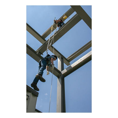 Two construction workers, equipped with safety gear and a French Creek Production Remote Prompt Rescue Kit RPR, are suspended by ropes on a steel frame structure against a clear blue sky. One climbs while the other uses the 3:1 mechanical advantage system to adjust equipment or a beam.