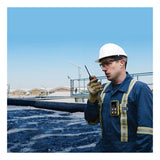 A worker in a hard hat and protective gear stands by a large outdoor industrial water tank, using a walkie-talkie and wearing the BW Technologies by Honeywell BW Flex4 Gas Detector (%LEL(F), O2, H2S, CO), with blue sky and buildings behind.