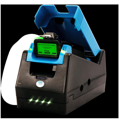 The GfG DS400 Docking Station for the G888/G999 Monitor, by GfG, is a black and blue multi-gas detector featuring a hinged lid and a digital display with text in German. It includes automatic calibration and has LED lights on the lower front panel to complement its sleek design.