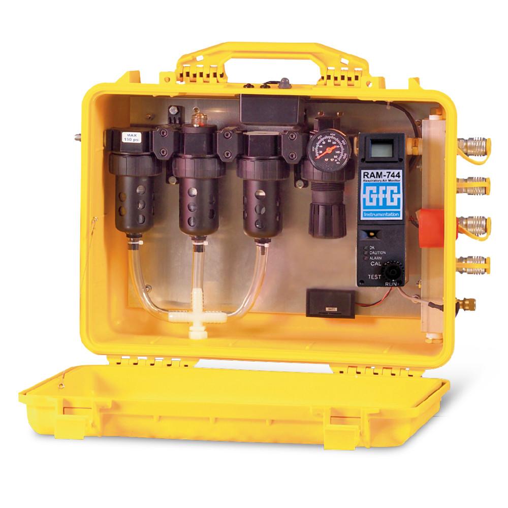 The GfG In-Line CO Monitor RAM 744, housed in a yellow portable case, features a comprehensive gas analysis system with gauges, tubes, and control dials. Designed for easy transport and use in various applications, this advanced system incorporates cylindrical components branded "RAM-744" and "GfG Instrumentation," highlighting the innovative AutoCal System. When the case is open, all equipment is clearly visible.