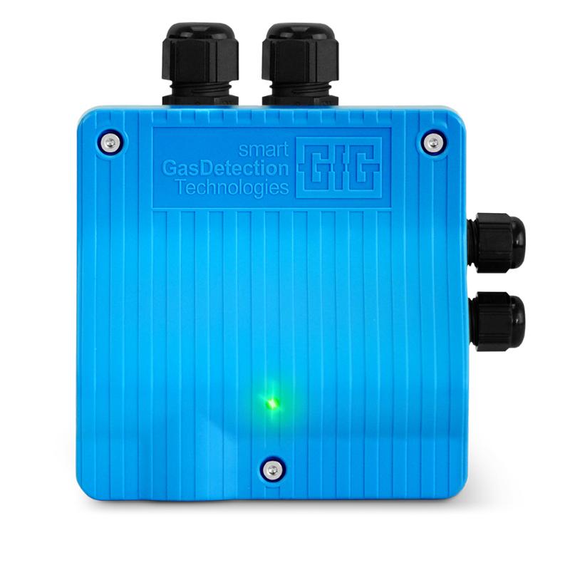 The GfG IR22 CO2 Fixed Transmitter IRR22-804_ is a blue gas detection device featuring two black connectors on the top and two on the right side. It prominently displays the "smart GasDetection Technologies" logo and text, incorporates an infrared sensor specifically designed for CO2 detection, and includes a small green light that indicates its operational status.