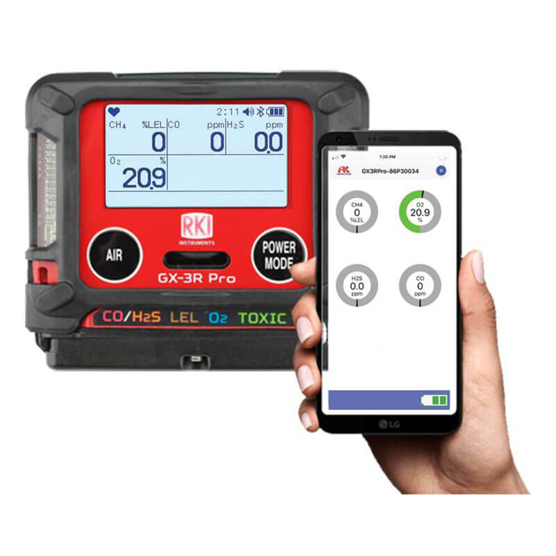 The RKI Instruments GX-3R Pro Gas Confined Space Monitor with Wireless Communication displays measurements for CO, H2S, LEL, and O2 on the device itself. It also communicates this data to a smartphone via Bluetooth, showcasing its connectivity feature.