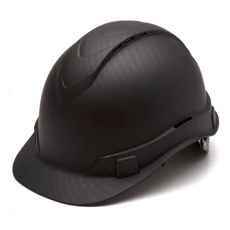 A Pyramex Safety Hydro Dipped Ridgeline Vented Cap Style hard hat in black, characterized by its sleek finish and low center of gravity, includes ventilation slits on top and an adjustable strap at the back. The helmet is displayed slightly tilted on a plain white background.