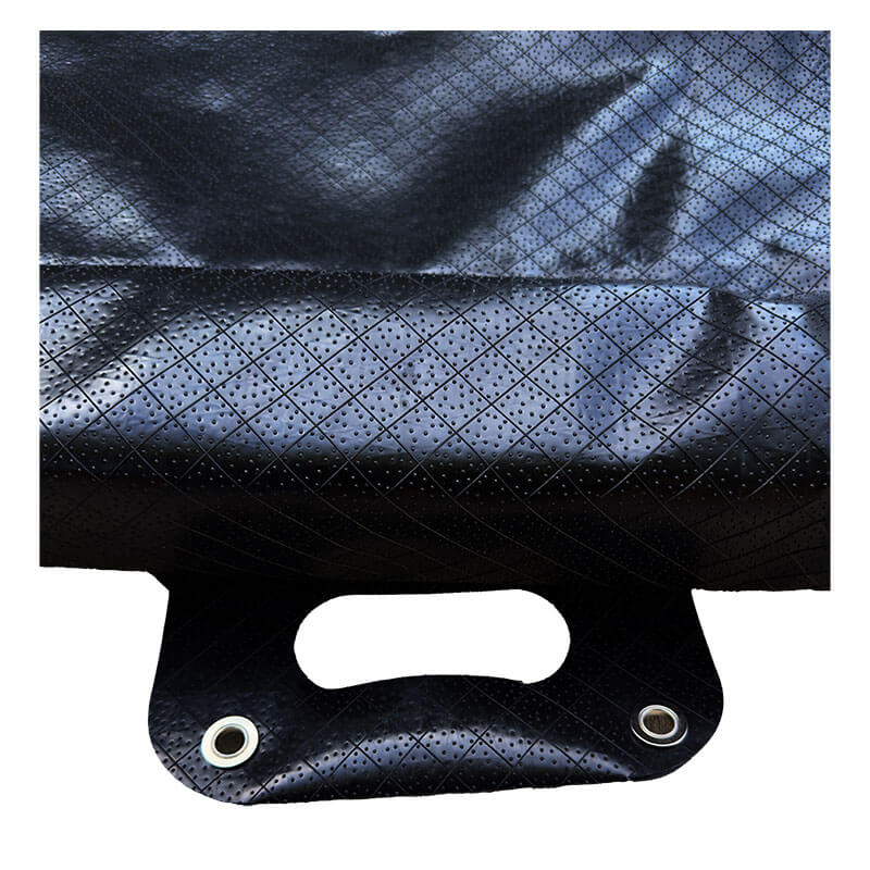 Close-up of a black, textured bag with a reinforced handle and metal grommets. The shiny, crisscross surface resembles that of UltraTech Foam Wall Model Containment Berm - Light-Duty by UltraTech.