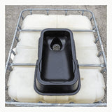 The UltraTech IBC Mini Funnel 0649, a black plastic sink with drain, sits atop a large white IBC with metal frame—creating a practical industrial liquid pouring system on a concrete surface.
