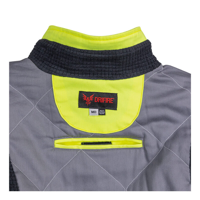 NSA DRIFIRE FR Hi-Vis Insulated Jacket JKT-01C3-HV features a gray and black flame-resistant design with a neon yellow inner collar, quilted stitching, and a DRIFIRE brand tag. On the back, a horizontal velcro strap is positioned below the tag. This jacket meets ANSI/ISEA 107 standards for enhanced safety.