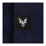 Close-up of the NSA DRIFIRE FR Range Flex Shirt Jacket JKT-6B in dark blue, showing visible stitching and a small black tag with a white stylized bird logo.