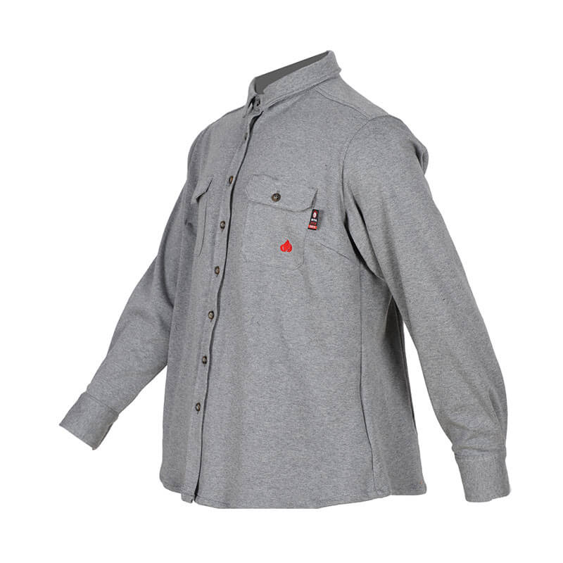 The ForgeFR Forge FR Ladies Knit Shirt LFRB1PS026 is a gray long-sleeve button-up shirt with a collar and two chest pockets. One pocket is accented with a small red logo. Designed as ideal workwear, it offers flame resistance for both style and safety. It is displayed on an invisible mannequin against a white background.