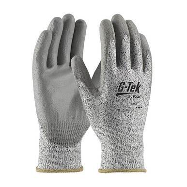 A pair of PIP G-Tek PolyKor Blended Gloves 16-530 featuring "G-Tek PolyKor" branding on the back. These gloves, blended with PolyKor, have a textured surface and knit wrist cuffs, providing excellent protection and grip.