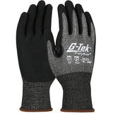 A pair of black and gray cut-resistant work gloves, branded as "PIP G-Tek PolyKor X7," prominently featuring safety ratings on the back. These nitrile-coated gloves offer a textured microsurface grip for improved handling and have brown edging at the wrist.