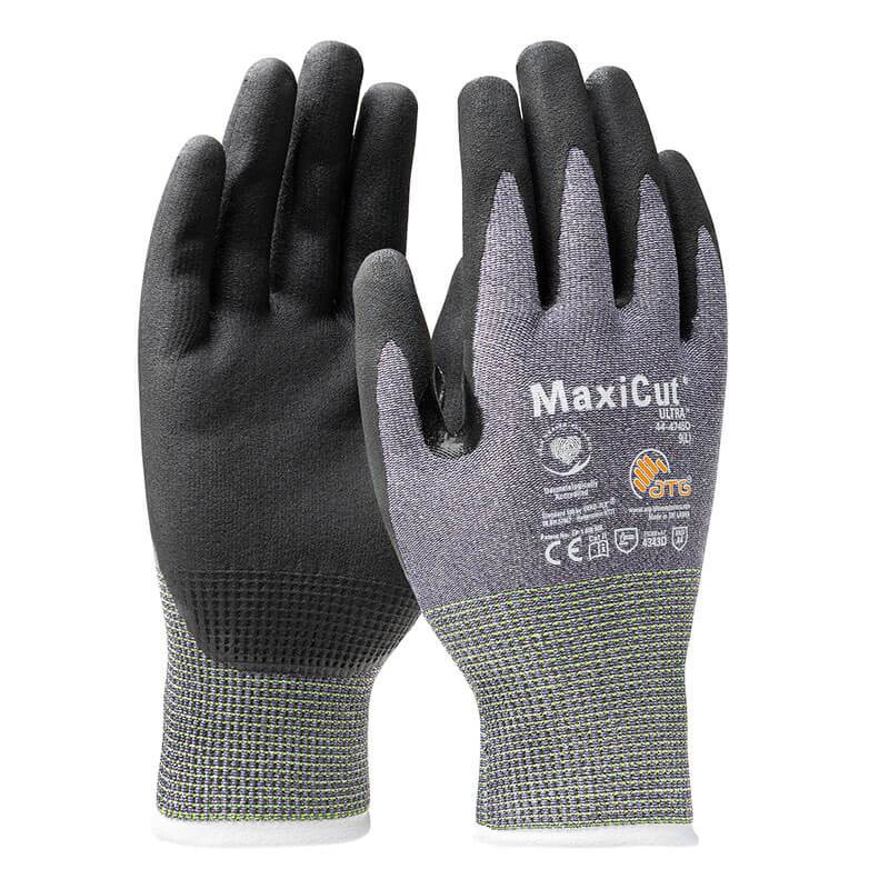 A pair of PIP MaxiCut Ultra Nitrile MicroFoam A4 Gloves, model 44-4745D, showcases a blend of gray and black hues with "MaxiCut" emblazoned on them. These gloves provide superior cut protection and enhanced grip thanks to their Nitrile MicroFoam construction. The textured surface covers both palms and fingers, while the knitted wrist cuff ensures a secure fit. Several certification symbols are also visible, attesting to their quality from Protective Industrial Products (PIP).