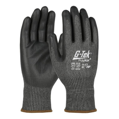 A pair of PIP G-Tek PolyKor gloves, featuring a black and gray color scheme with nitrile-coated foam grips. These gloves have textured palms, elastic cuffs, and the "G-Tek PolyKor" label clearly displayed. Additionally, they offer touchscreen compatibility for extra convenience.