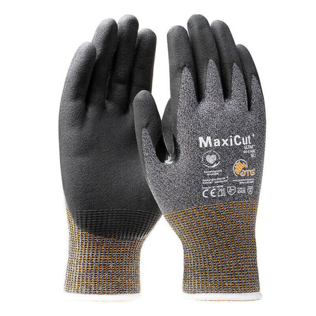 Two PIP MaxiCut Ultra Nitrile MicroFoam A5 gloves in black and grey are displayed upright. They feature microfoam palms coated with nitrile for improved grip, showcasing the PIP brand name and safety certifications on the back. With cuffed wrists adorned with a yellow pattern, these gloves offer both style and functionality.