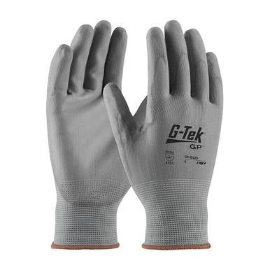 Two gray PIP G-Tek GP Nylon Polyurethane Coated Gloves 33-G125 from Protective Industrial Products are displayed with palms forward and fingertips up. These gloves offer excellent dexterity, featuring a textured surface for enhanced grip and abrasion resistance, alongside a smooth knit cuff at the wrists.