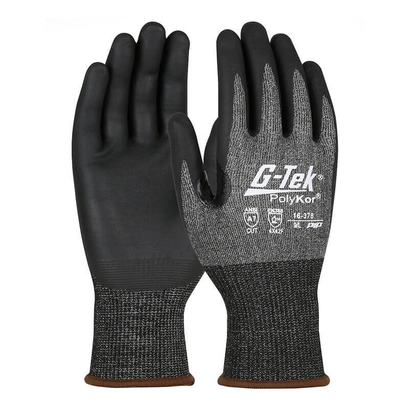 The PIP - Protective Industrial Products G-Tek PolyKor X7 gloves in black and gray provide impressive cut resistance with textured palms. They feature brown cuffs, protective symbols on the back, and a nitrile coated foam grip for enhanced hold, ensuring durability while maintaining touchscreen compatibility for versatile use. Available in packs of 12 pairs (product code: 16-378).