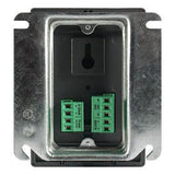 The Macurco CO2 Fixed Gas Detector Controller Transducer by Macurco features a metal wall plate with a rectangular opening, equipped with two sets of green terminal blocks for wire connections, making it ideal for fan control systems. The plate includes a keyhole cutout for easy mounting, and certification symbols are visible in the corners, making it perfect for commercial refrigeration applications.