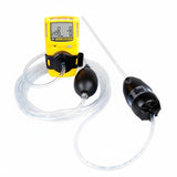 A BW Honeywell GasAlertMicroClip gas detection device in yellow, featuring a digital screen, is linked to the BW Honeywell Manual Aspirator Pump (Model: MC-AS01) using clear tubing. This arrangement leverages cutting-edge gas monitors to efficiently sample and measure gas levels.