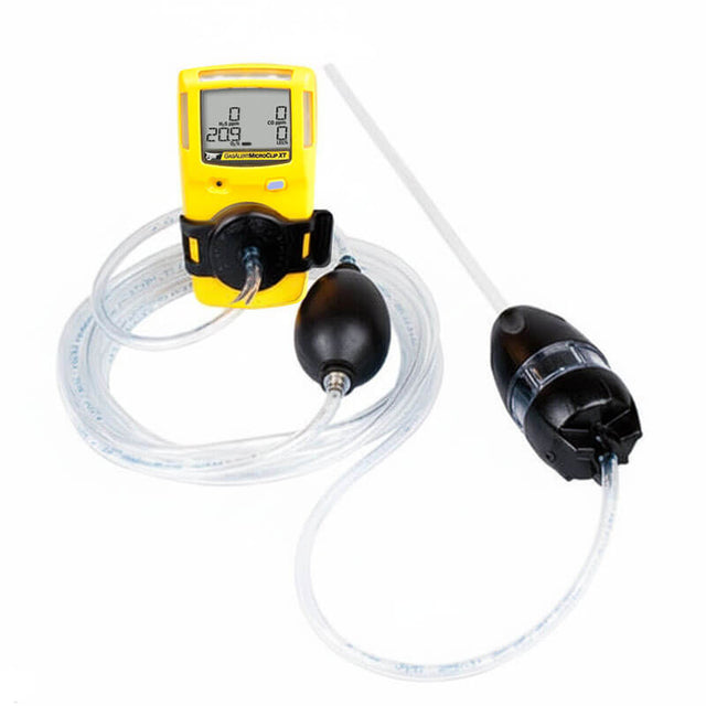 A BW Honeywell GasAlertMicroClip gas detection device in yellow, featuring a digital screen, is linked to the BW Honeywell Manual Aspirator Pump (Model: MC-AS01) using clear tubing. This arrangement leverages cutting-edge gas monitors to efficiently sample and measure gas levels.
