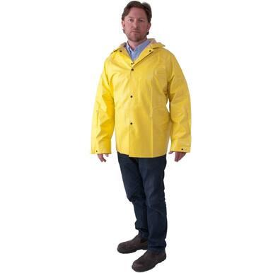 A person is wearing the MCR Safety Premium Neoprene Rain Jacket 800JH, a flame retardant yellow raincoat from MCR Safety, over a blue shirt, standing with hands by their sides. They are also sporting dark jeans and brown shoes against a plain white background.