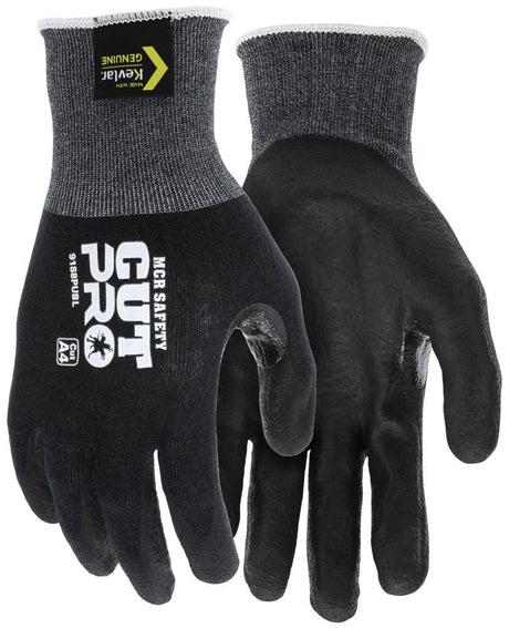 These MCR Safety Cut Pro 18 Gauge Kevlar PU Work Gloves, marked with "MCR Safety" and "Kevlar Genuine," feature black gloves with grey cuffs designed for cut resistance. They provide ANSI Cut Level A4 protection, enhancing safety with their textured surface for better grip while delivering Kevlar comfort.