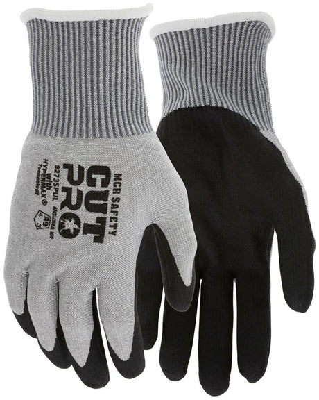 The MCR Safety Cut Pro 13G HyperMax PU Coated Gloves, model 9273SPU, feature gray and black cut-resistant design with ribbed cuffs and the distinctive "Cut Pro" and "MCR Safety" text. The gloves have a black palm that contrasts elegantly with the gray upper, further enhanced by a HyperMax PU coating. These gloves deliver superior protection with an ANSI cut level A9 rating, available in packs of 12 pairs.