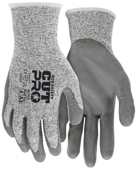 These MCR Safety Cut Pro 13G HyperMax PU Coated Gloves come in gray and offer abrasion resistance with a textured grip on the palms. The left glove features safety certifications alongside the "CUT PRO" branding in black text. They boast a speckled pattern on the back, providing superior cut protection and durability.