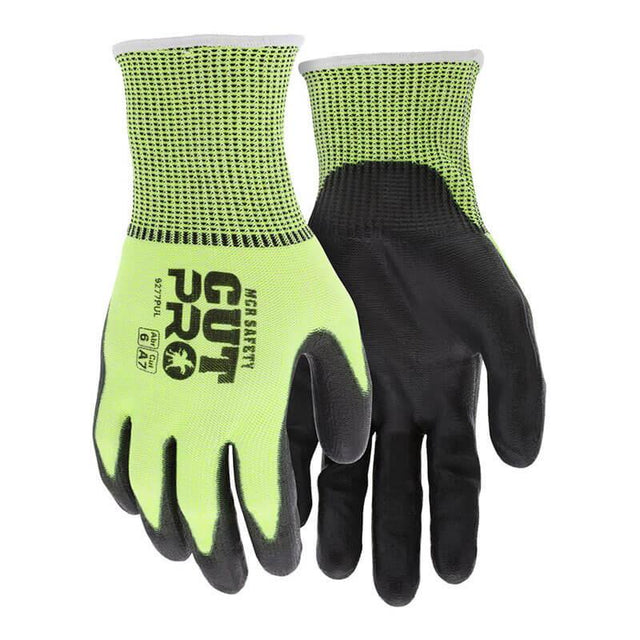 The MCR Safety Cut Pro 13G HyperMax PU Coated Hi-Vis Gloves 9277PU are displayed. These gloves, available as a pack of 12 pairs, have a neon yellow and black color scheme with "Cut Pro" text on the back. The palms feature a black rubber polyurethane coating for enhanced grip. Their bright, hi-vis design and texture suggest they offer cut resistance for workplace safety.