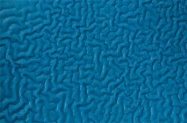 Close-up of a textured blue surface showcasing an intricate pattern of wavy, interconnected lines reminiscent of abstract art or a topographic map. The detailed design calls to mind the reinforced weave found in the MCR Safety Flex Tuff Cut-Resistant Kevlar Glove 9687, renowned for its cut-resistant properties and safety features.