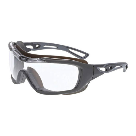 Introducing the MCR Hydroblast HB5 Series Safety Glasses by MCR Safety, available in a box of 12. These glasses feature gray and black protective styling with clear wraparound lenses and a sturdy frame. They are enhanced with MAX6 anti-fog technology, ensuring clear vision during intense activities. The temples are designed with ventilation holes for added comfort, and they offer splash resistance for increased safety.