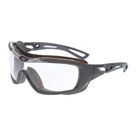 Introducing the MCR Safety Hydroblast HB5 Series Safety Glasses, available in a box of 12. These splash-resistant sports goggles feature clear lenses and a gray frame, equipped with MAX6 anti-fog technology. The design includes temple arms with ventilation holes for enhanced breathability and comfort, while providing crucial UV protection and maintaining a robust, sporty appearance.