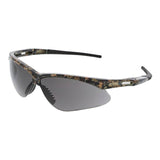 A pair of safety glasses designed in a sporty style, featuring a Mossy Oak camouflage-patterned frame and dark tinted polycarbonate lenses from MCR Safety, available as the MCR Memphis Mossy Oak UV-AF Anti-Fog Safety Glasses.