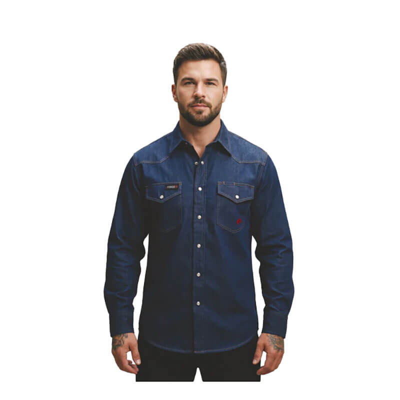 A man with short dark hair and a beard wears the ForgeFR Forge FR Solid Shirt Denim MFRSLD-002, NFPA 2112 compliant, standing against a plain white background.