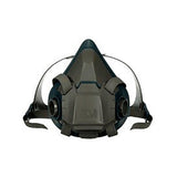 The 3M Half Facepiece Reusable Respirator 6500 Series, in charcoal gray, is designed for safety and respiratory protection with black pre-filters. It offers adjustable straps for a secure fit and is compatible with 3M cartridges.