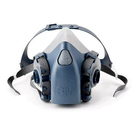 A 3M 7500 Series Half Facepiece Respirator, colored blue and grey, is featured with dual filter attachments and adjustable straps, offering protection against airborne particles and pollutants. This NIOSH-approved respirator is positioned face-up on a white background.