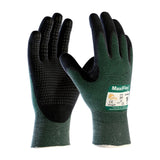 A pair of PIP MaxiFlex Cut Nitrile gloves in black and green, showcasing a textured MicroFoam grip. One glove is displayed upright with the palm visible, while the other shows the back along with its label. These gloves from Protective Industrial Products are touchscreen compatible and feature ribbed cuffs for a secure fit.