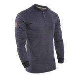 The NSA TECGEN FR Long Sleeve Henley C541N is a dark navy blue, long-sleeved shirt featuring a black collar and button placket. With Carbon Fabric Technology, it provides moisture-wicking comfort. The design includes an embroidered pattern on the right sleeve and ribbed cuffs for a finished look.