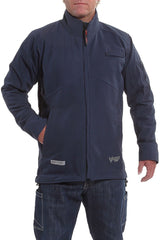 A person is wearing the NSA DRIFIRE IA FR Windbreaker Jacket in navy blue, which has long sleeves, a zippered front, and a high collar. The jacket, made from GORE PYRAD fabric, includes pockets and logo details near the hem. This stylish look is paired with jeans, while the person's left hand rests in one of the jacket's pockets.