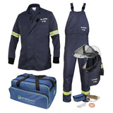 The NSA AirLite 12 Cal Jacket & Bib Overall Kit with Vented Lift Front Shroud includes a flame-resistant AirLite jacket, overalls with reflective stripes, a helmet equipped with a vented lift front shroud and face shield, gloves, and a storage bag. The navy blue equipment is clearly marked with "Arc Rating 12 CAL" on the garments.