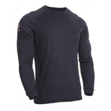 The NSA DRIFIRE FR Helix Long Sleeve T-Shirt TEE-HX is showcased on a mannequin, providing arc flash protection. This black long-sleeve crew neck shirt includes a small chest pocket and displays a subtle logo on one sleeve. It boasts a simple, fitted design with ribbed cuffs and stitching details, effortlessly combining safety and style.