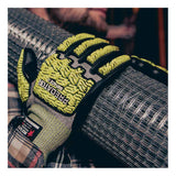 A person wearing MCR Safety Predator Hi-Vis Mechanics Gloves with HyperMax (PD6952) is gripping a roll of metal wire mesh. The yellow and black impact-resistant gloves feature textured padding and have the “Predator” brand name visible on the back.