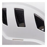 Close-up view of a Petzl STRATO VENT Helmet A020BA0 in white, featuring black ventilation slits with a mesh pattern for optimal airflow. This helmet, designed by Petzl for climbing professionals, offers a customizable fit to ensure comfort and safety. Its smooth and slightly curved surface makes it ideal for technical rescue scenarios.