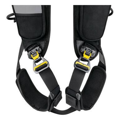 Close-up of the black and yellow automatic buckles on the Petzl Newton Easyfit International Harness C073FA, featuring adjustable padded shoulder straps for enhanced safety and comfort.