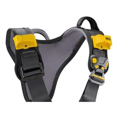 Close-up of a black and gray Petzl ASTRO BOD FAST International Harness C083BA0_ by Petzl, showcasing its bright yellow buckles. This harness includes adjustable straps, sturdy connectors, and a CROLL L ventral rope clamp for secure attachment and optimal safety in rope access scenarios.