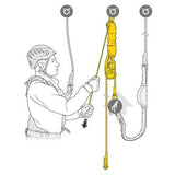 An illustration features an individual using the Petzl JAG Rescue Kit K090AA0 to ascend a rope. Equipped with a helmet and harness, they pull the rope through the brightly highlighted yellow pulley system by Petzl, with arrows indicating motion. This haul kit aids in efficiently navigating their ascent.