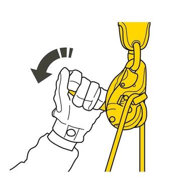 Illustration of a gloved hand gripping the Petzl JAG Rescue Kit K090AA0_, a yellow climbing descender device attached to a rope, part of the essential Petzl rescue kit. An arrow indicates the direction to pull for operation, suggesting a climbing or rappelling context.