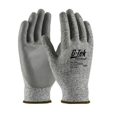 A pair of gray PIP PolyKor Blended Polyurethane Coated Gloves 16-150, featuring polyurethane-coated palms and black text on the back, designed by Protective Industrial Products for mechanical hazard protection. The seamless knit construction provides enhanced flexibility and grip. The gloves are displayed with palms facing forward and slightly angled.